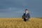 Happy farmer. buisnessmen in a wheat field