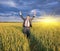 Happy farmer, businessman, standing in wheat field