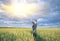 Happy farmer, businessman, standing in wheat field