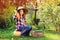 happy farmer child girl with autumn harvest - organic pumpkins, carrots and zuccini