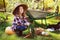 Happy farmer child girl with autumn harvest - organic pumpkins, carrots and zuccini