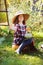 Happy farmer child girl picking fresh home growth carrot harvest