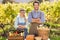 Happy farmer couple with arms crossed