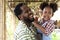 Happy farmer family work in agriculture farm, portrait of smiling African father holding up his black curly haired little girl