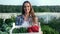 Happy farmer female carrying box with fresh organic vegetables. Shot on RED Raven 4k Cinema Camera