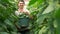 Happy farmer holding bucket with fresh cucumbers.