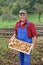 Happy farmer show his organic potato