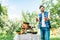 happy farmer showing ripe ecological vegetables