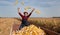 Happy farmer throwing corn cobs in the air during harvest