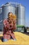 Happy Farmer Throwing Freshly Harvested Corn Maize Grains Against Grain Silo