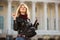 Happy fashion blond woman in leather jacket with handbag