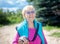 Happy, fashionable 90-year-old grandmother with gray hair, sunglasses and a smile in nature on a Sunny summer day.