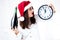 Happy fat Santa girl. A model in a santa hat. XXL a woman celebrating Christmas and a new year. Female holds a shapanese and is s