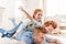 Happy father with adorable redhead children playing and having fun together on floor