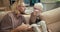 Happy father, a blond man in glasses with a beard explains to his little son, an albino boy with white hair color in