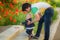 Happy father and child playing together on the poppy meadow.