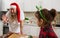 Happy father and cute child daughter having fun preparing baking cookies biscuit. Funny overweigh father in Santa hat and tattooed