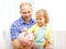 Happy father and daughter with big piggy bank