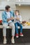 happy father with daughter hugging and holding glasses with fresh juice