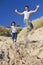 Happy Father and Daughter Jumping At Beach