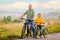 Happy father and daughter take bike ride in nature in autumn