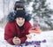 Happy father with his son outside with snowman