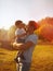 Happy father holding on hands child son warm autumn evening, sunny family photo