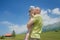 Happy father holding little daughter on his arms high Alpine meadow