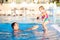 Happy father with little daughter in swimming pool