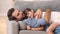 Happy father lying on sofa hugging kid rest cuddle together