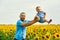 Happy father playing with his son on a summer walk .