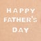 Happy Father`s Day Background. Wooden letters on brown background flat lay. Fathers day.