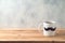 Happy Father`s day concept with coffee mug and mustache over wooden background