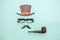 Happy Father\'s day concept. Sign of hat mustache with pipe glasses  on pastel blue background. Man silhouette symbol