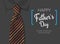 Happy father`s day greeting card black and orange tie