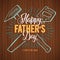 Happy Father`s Day! Greeting retro card. A hammer and saw, the dad`s tools. Wood Background.