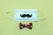 Happy Father`s Day. Protective surgical mask with false mustache and bow tie.Coronavirus epidemic concept