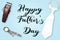 Happy father`s day with tie and machine hair and watch hand on blue background.