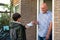 The happy father with smiling face give medical mask and alcohol spray to son