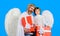 Happy father and son in angel costume with present. Valentines angels with white wings with gift box.