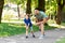 Happy father and son compete in running at park