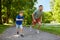 Happy father and son compete in running at park