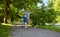 Happy father and son compete in running at park