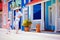 Happy father and son enjoy life, dancing on caribbean village street