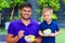 Happy father and son enjoying fresh fruit salad