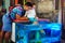 Happy father and son at fish pedicure treatment at street market