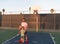 happy father and son play basketball with ball on playground, family weekend