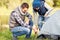 Happy father and son setting up tent outdoors