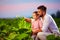 Happy father and son on their tobacco plantation, at sunset