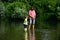 Happy Father and Son together fishing in summer day on the river. Anglers. Happy family concept - father and son